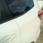 Before and after photographs of a damaged white Subaru that was repaired by Elite Paint & Body Shop in West Palm Beach, Florida